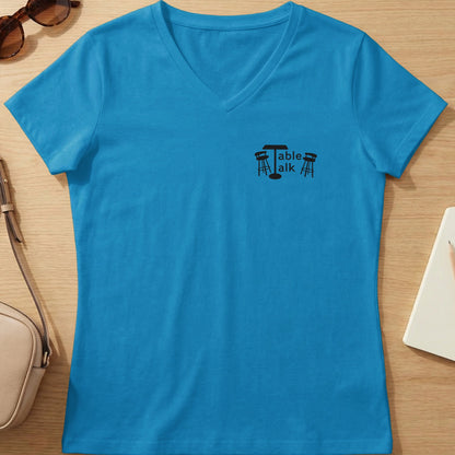 Blue V-neck t-shirt with "Table talk" logo and stools.