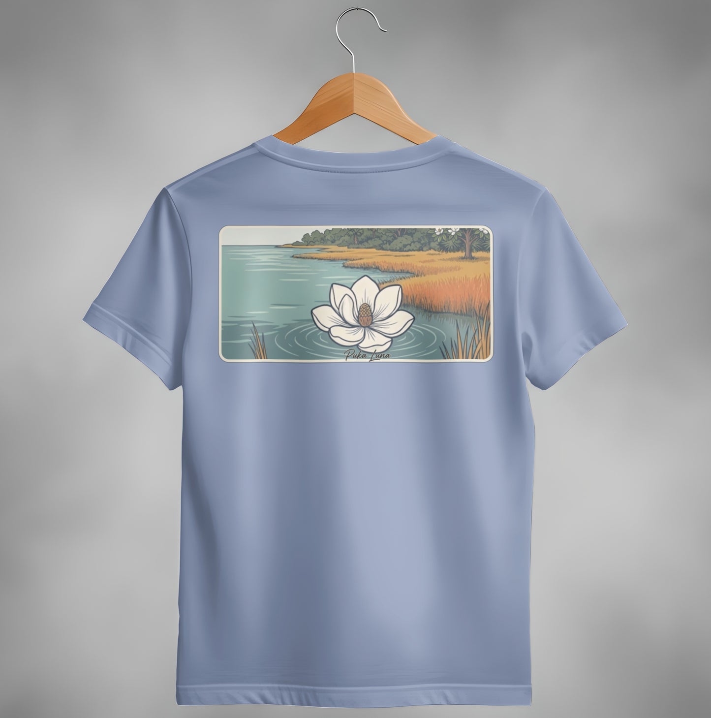 Blue t-shirt with illustration of a water lily on water with reeds.