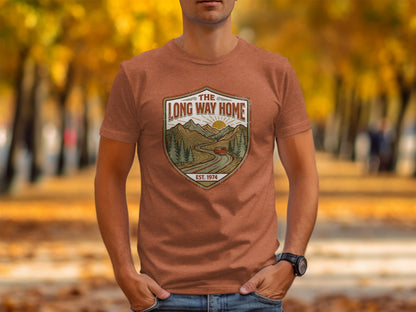 Rugged The Long Way Home | Vintage Adventure Wilderness Shirt: Brown t-shirt with circular logo depicting a winding road through mountains and the text "THE LONG WAY HOME".
