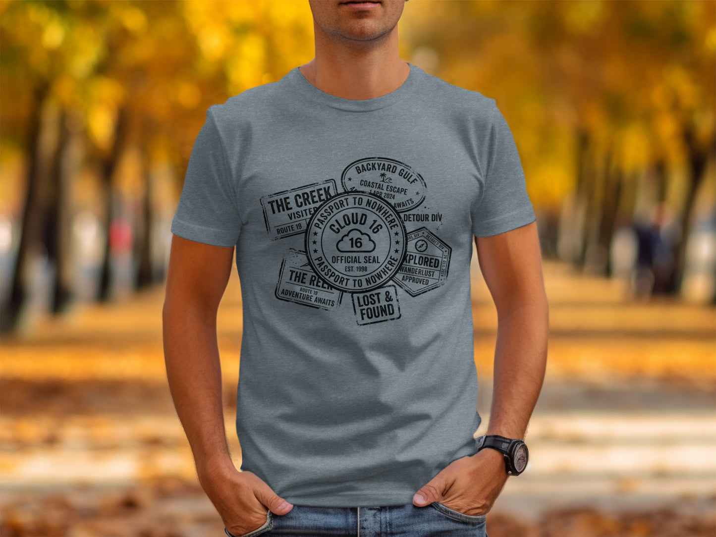 Rugged Wanderlust Passport Stamp Graphic Wilderness Shirt: Grey t-shirt with passport stamps from "The Creek" and "Backyard Gulf."