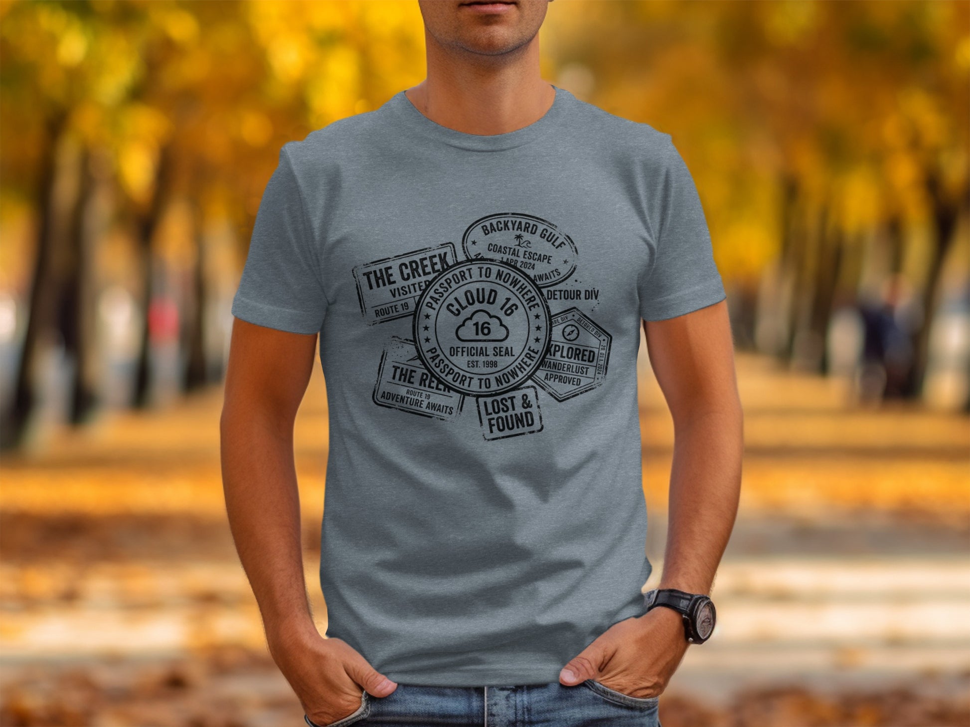 Rugged Wanderlust Passport Stamp Graphic Wilderness Shirt: Grey t-shirt with passport stamps from "The Creek" and "Backyard Gulf."