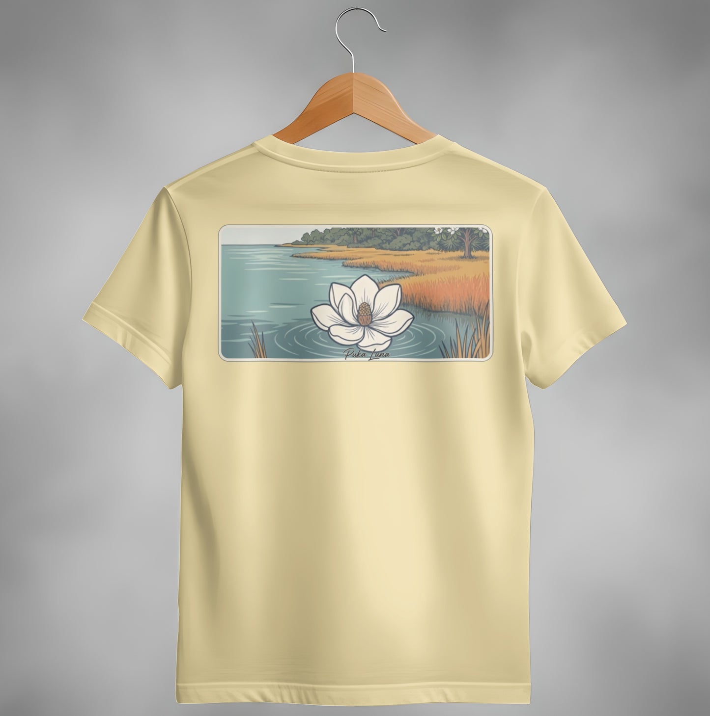 Yellow t-shirt with magnolia flower and wetland scene graphic.