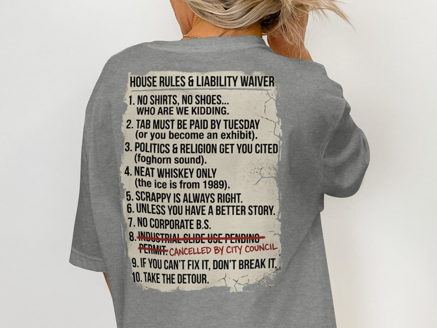 Grey t-shirt with text listing "House Rules & Liability Waiver" and ten numbered rules.
