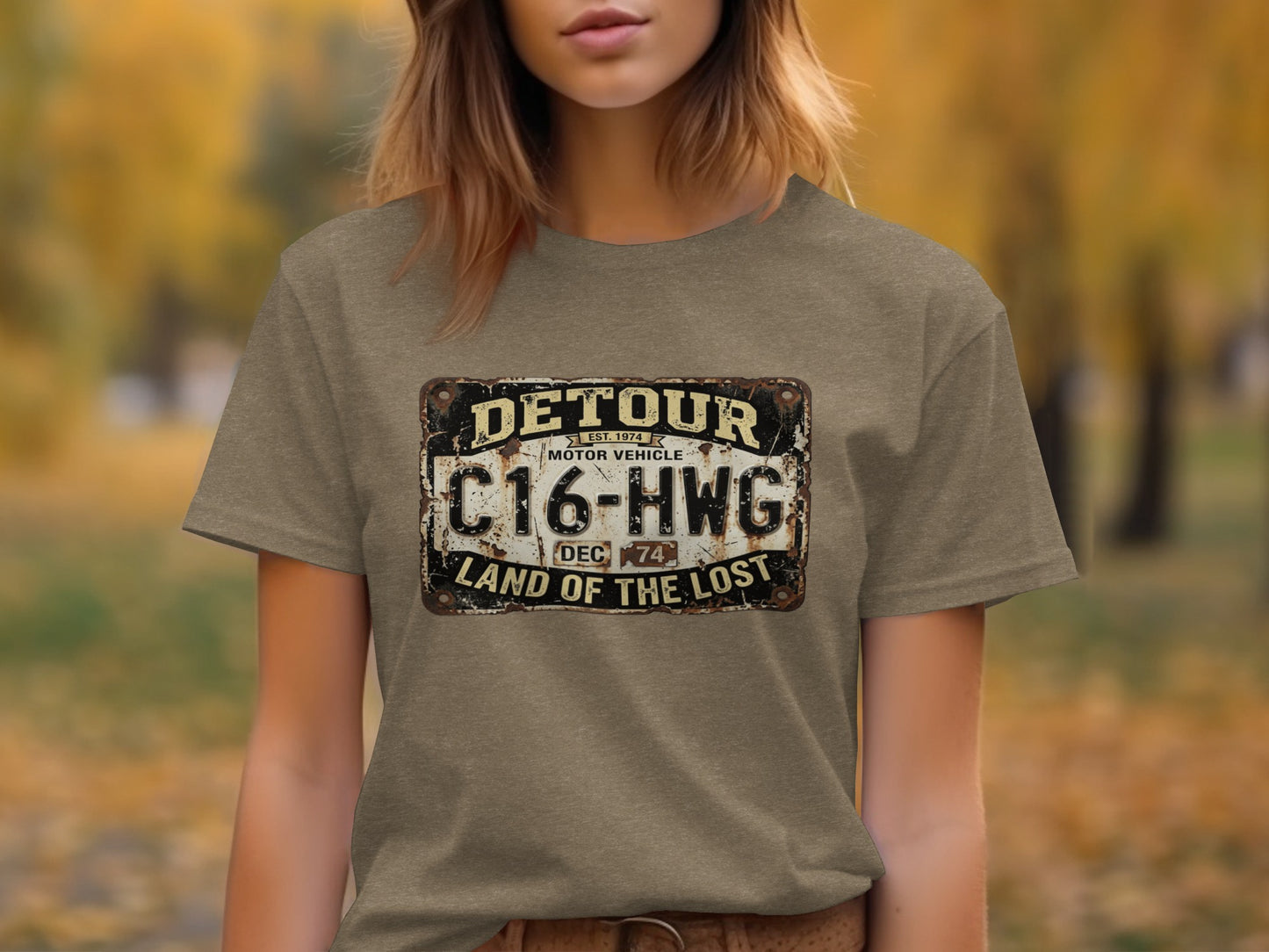 Detour 'Land of the Lost' Vintage | Vintage Outdoor Apparel: Brown t-shirt with a distressed license plate graphic reading "DETOUR C16-HWG LAND OF THE LOST."