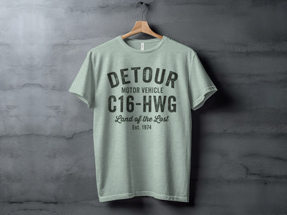 Light green t-shirt with DETOUR MOTOR VEHICLE C16-HWG Land of the Lost Est. 1974 graphic.