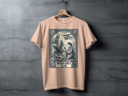 T-shirt featuring a framed illustration of a woman with an eagle and a biplane, with "Weird Girls Club" text.
