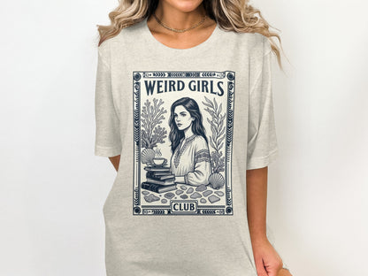T-shirt featuring "WEIRD GIRLS CLUB" with illustration of a woman and sea elements.