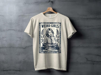 T-shirt with "WEIRD GIRLS CLUB" text and illustration of a woman reading surrounded by books.