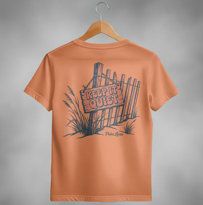 Orange t-shirt with "Keep It Quiet" sign and fence illustration.