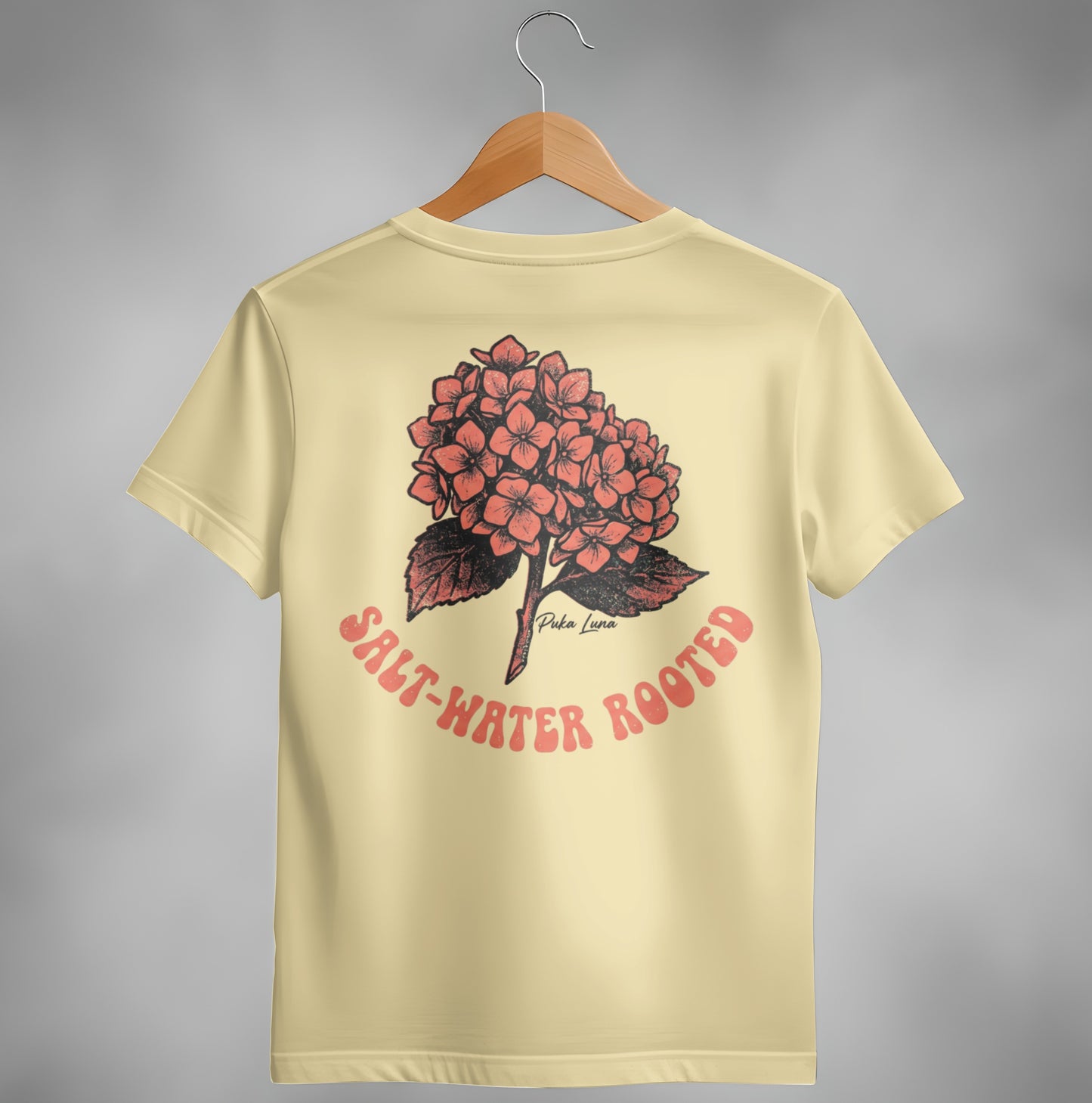 Pale yellow t-shirt with coral hydrangea graphic and "Salt-Water Rooted" text.